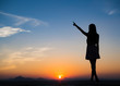 © max_play - Silhouette of free woman enjoying freedom feeling happy at sunset. Serene relaxing woman in pure happiness