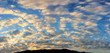 panorama sunset sky with puffy white clounds at the evening