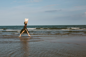 Wall Mural - Young happy woman in big white hat enjoy freedom on blue sea. Happiness, summer travel