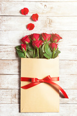 Wall Mural - Love or valentine's day concept. Red beautiful roses in envelope