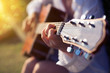 Female hand playing guitar outdoor