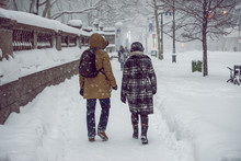 People Walking On New York City Manhattan Street During Strong Snow Storm Blizzard And Cold Weather.
