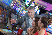 Group Of Friend Playing With Slot Machines