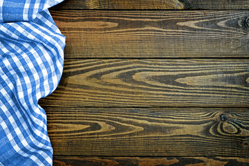 Wall Mural - Blue checkered napkin on wooden table