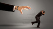 © ra2 studio - Businessman running away from a huge hand