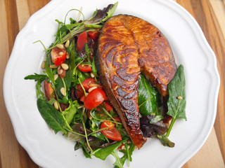 Canvas Print - Baked marinated salmon with fresh salad of arugula and cherry to