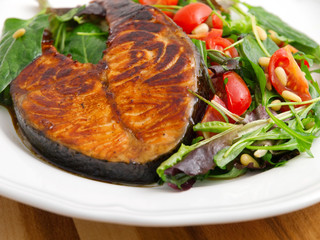 Canvas Print - Baked marinated salmon with fresh salad of arugula and cherry to