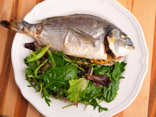 Canvas Print - Baked sea bream with green salad shot from above