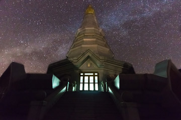 Wall Mural - blue and red milky way on a background and temple at doi inthanon, thailand.