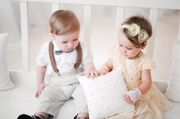 two babies wedding - boy and girl dressed as bride and groom