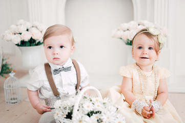 two babies wedding - boy and girl dressed as bride and groom