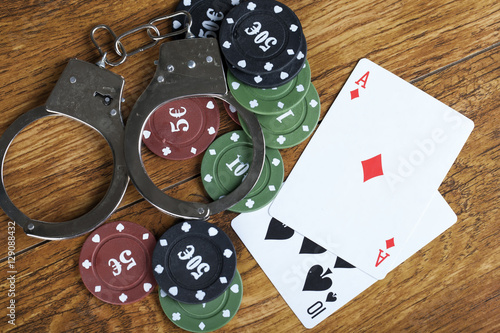 фотография Illegal gambling concept blackjack with betting chips and handcuffs