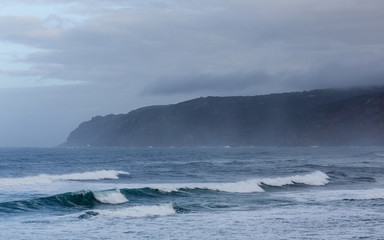 Autumn foggy day on the shores of the Atlantic Ocean in Sintra, Portugal