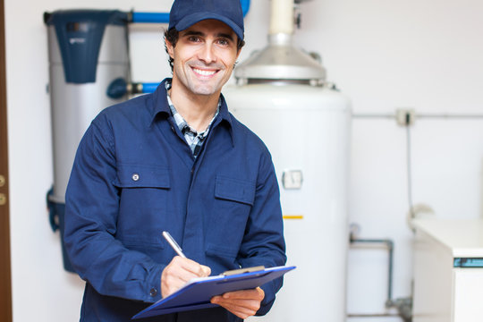 technician servicing an hot-water heater