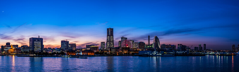 Wide panorama of Yokohama Minato Mirai 21 seaside urban area in Japan at dusk