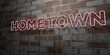 HOMETOWN - Glowing Neon Sign on stonework wall - 3D rendered royalty free stock illustration.  Can be used for online banner ads and direct mailers..