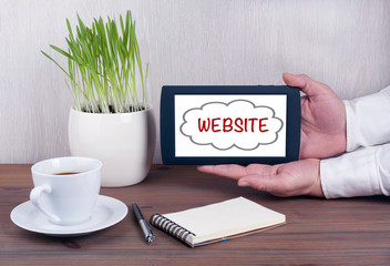 Wall Mural - WEBSITE. Digital tablet computer with isolated screen in male hands.
