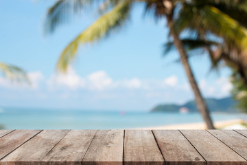 Wood table top and blurred summer beach and sky background. - can used for display or montage your products.