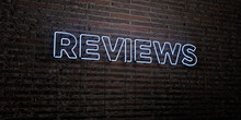 REVIEWS -Realistic Neon Sign on Brick Wall background - 3D rendered royalty free stock image. Can be used for online banner ads and direct mailers..