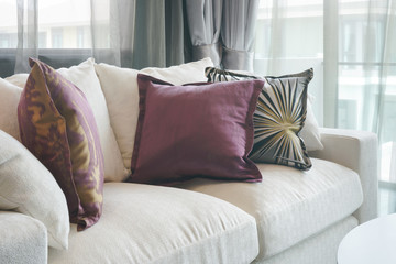 Wall Mural - Beautiful purple and green pillows on white sofa in living room