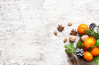 christmas food background. tangerines. pine cones, nuts and spices