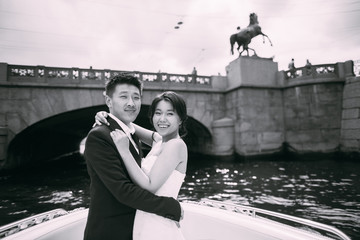 Wall Mural - Bride and groom are floating on a boat on the city's rivers and canals