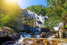 Mae Ya Waterfall With Green Trees And Blue Sky Backgroundat Doi Inthanon National Park,One Of The Famous Waterfalls Of Chiang Mai.