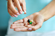 © puhhha - Vitamins And Supplements. Female Hand Holding Colorful Pills