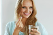© puhhha - Beautiful Smiling Woman Taking Vitamin Pill. Dietary Supplement