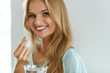 © puhhha - Beautiful Smiling Woman Taking Vitamin Pill. Dietary Supplement