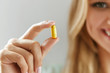 © puhhha - Beautiful Woman Holding Fish Oil Pill In Hand. Healthy Nutrition