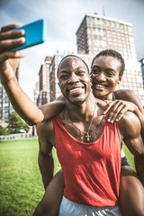 Wall Mural - Couple running and taking a selfie