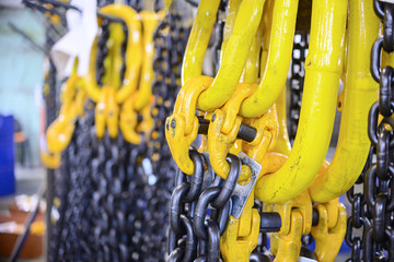 Black steel chain and yellow cargo hooks.