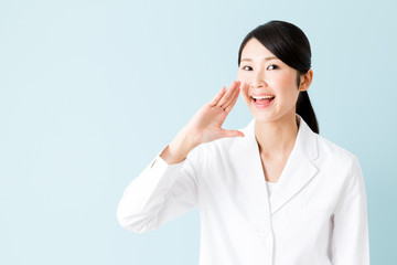 Wall Mural - portrait of young asian nurse isolated on blue background