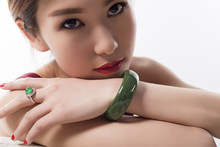 With A Jade Bracelet And Ring Young Beautiful Woman.