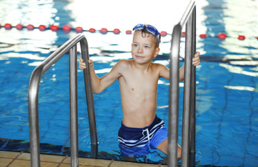 Cute boy in the sport swimming pool