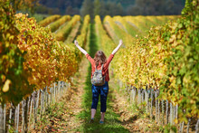 Woman Walking In Tuscan Vineyards In Val D'Orcia, Tuscany, Italy
