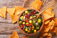 Salsa With Mangoes, Peppers, Cilantro And Onion Closeup And Nachos. Horizontal Top View
