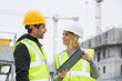 © eric - Woman in protective workwear and construction worker in construction site