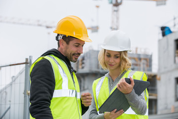 Construction manager and engineer working on building site