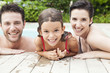 © PhotoAlto - Portrait of happy family relaxing together in pool