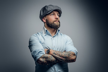 Wall Mural - Bearded male in a shirt and tweed cap.