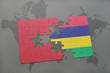 puzzle with the national flag of morocco and mauritius on a world map