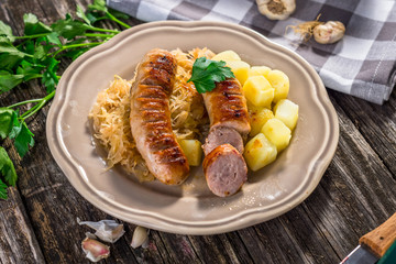 Poster - Grilled sausages,  potatoes and sauerkraut