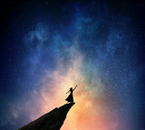 Fototapeta Kosmos - Woman against starry sky . Mixed media