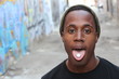 Young African boy with candy pill in his tongue