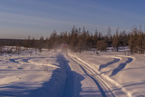 Fototapeta Na ścianę - Winter landscape with forest, snow and ice road and SUV truck.