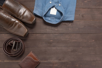 Elegant set: brown men's shoes, brown leather belt, blue shirt,