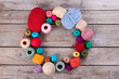 © margostock - Colored yarn on a vintage wooden background.