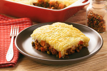 Shepherd Pie (portion) On Plate On Wooden Table.